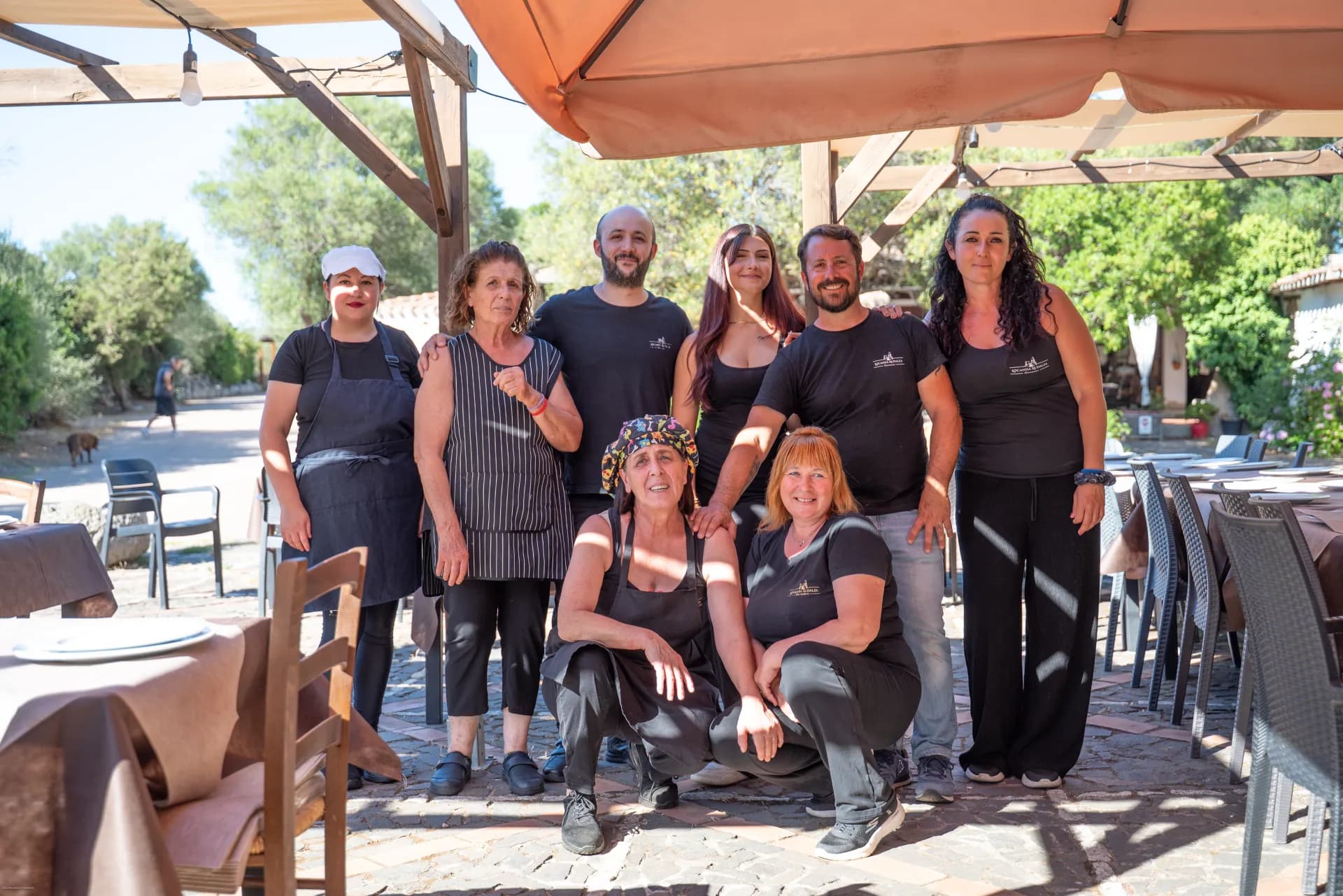 The family and staff of Locanda Rudalza in front of the restaurant