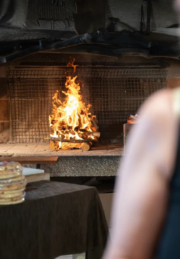 The live fire in the wood-burning hearth at Locanda Rudalza